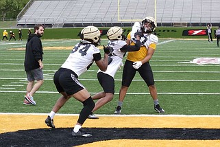 UAPB tight ends run a drill during an April 6 football practice as tight ends coach Chris Forestier looks on. (Pine Bluff Commercial/Tanner Spearman)